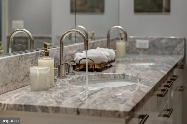 a living room with furniture a chandelier and a large window
