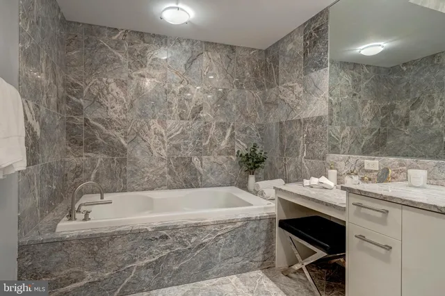 a lobby with furniture and a large mirror