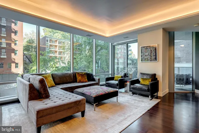 a living room with furniture and a floor to ceiling window