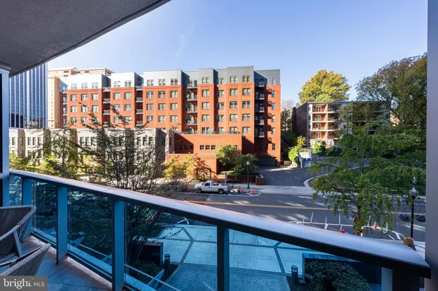 a view of a kitchen with kitchen island stainless steel appliances refrigerator stove microwave and cabinets