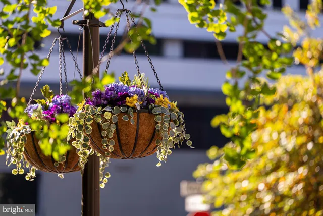 a kitchen with granite countertop a refrigerator and white cabinets