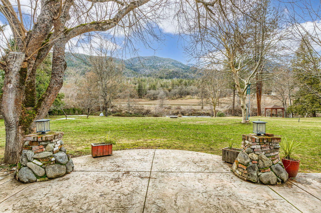 3828 Upper Applegate Road Jacksonville, OR 97530 - Photo 60 of 69 a view of a chairs and table in backyard of the house