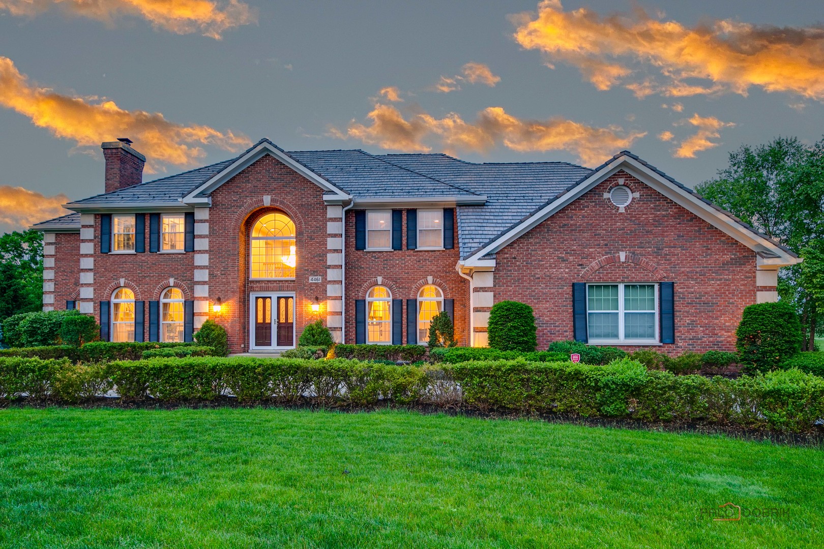 a front view of a house with garden