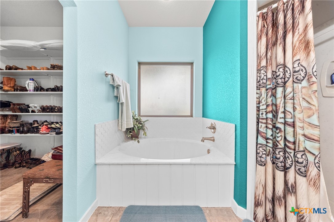 452 County Road 470 Chilton, TX 76632 - Photo 17 of 47 a bathroom with a bathtub and shower