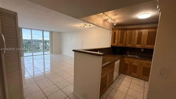 a kitchen with a refrigerator and a sink