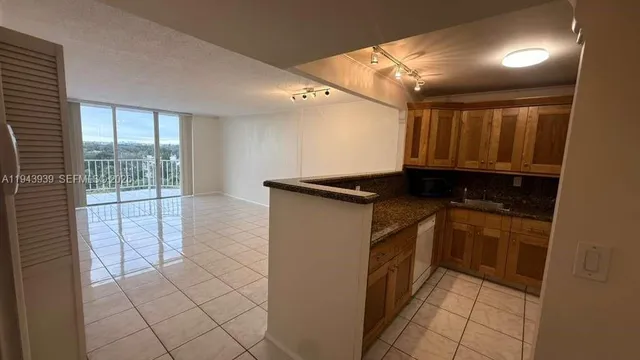 a kitchen with a refrigerator and a sink