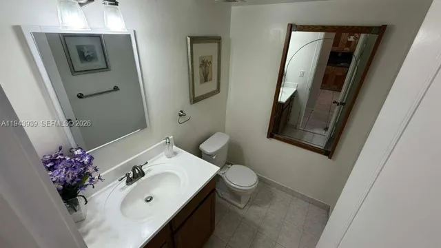 a bathroom with a sink toilet and mirror