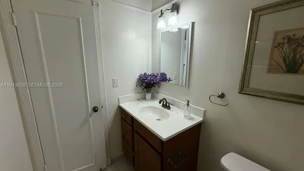 a bathroom with a sink vanity and a mirror