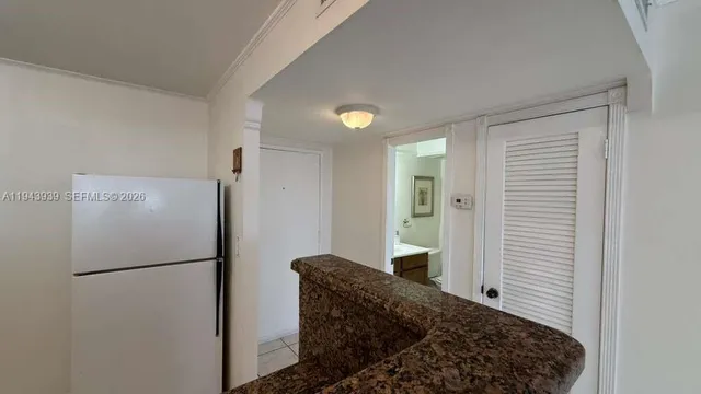 a kitchen with a refrigerator and a stove