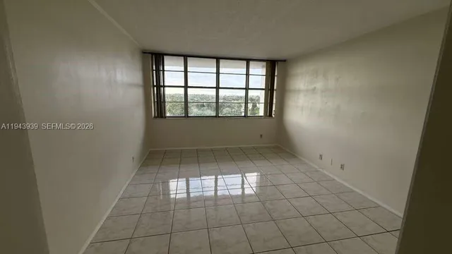 an empty room with white walls and tiles