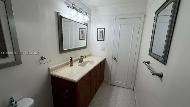 a bathroom with a sink vanity and mirror