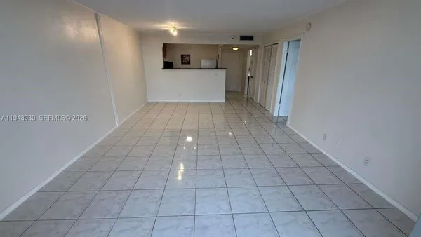 a view of a livingroom with an empty space and a window
