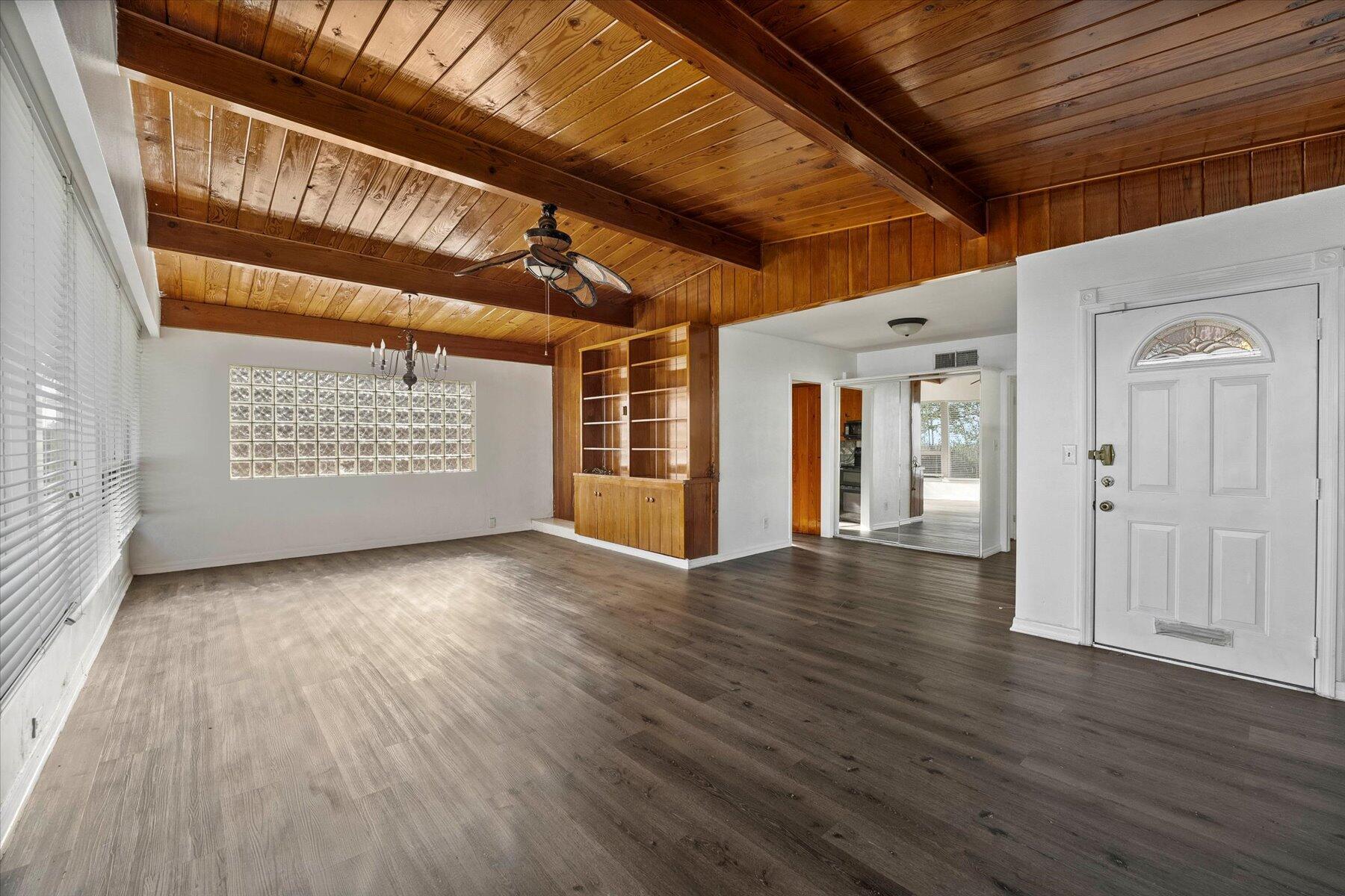 101 South Colorado Avenue Stuart, FL 34994 - Photo 3 of 17 an empty room with wooden floor and windows