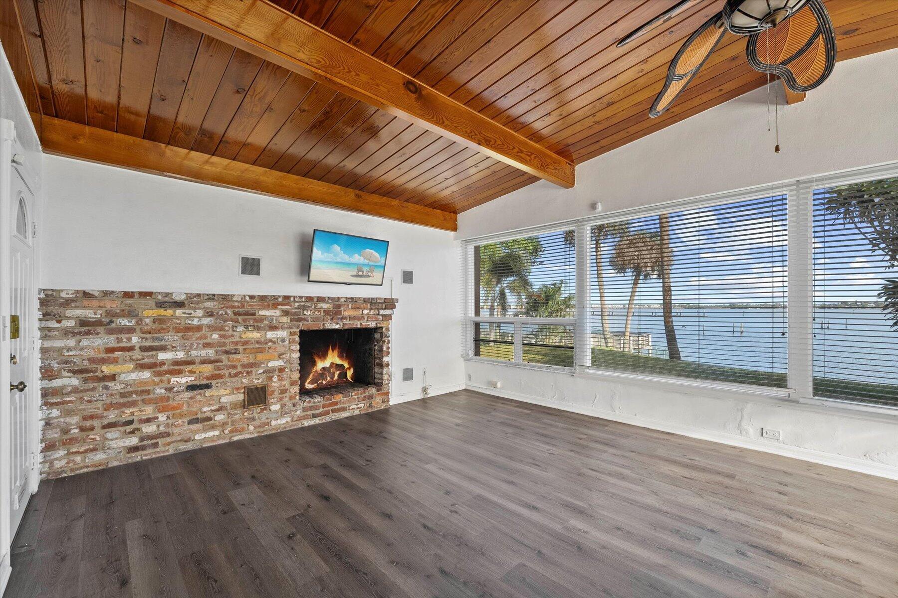 101 South Colorado Avenue Stuart, FL 34994 - Photo 5 of 17 a view of an empty room with wooden floor fireplace and a window