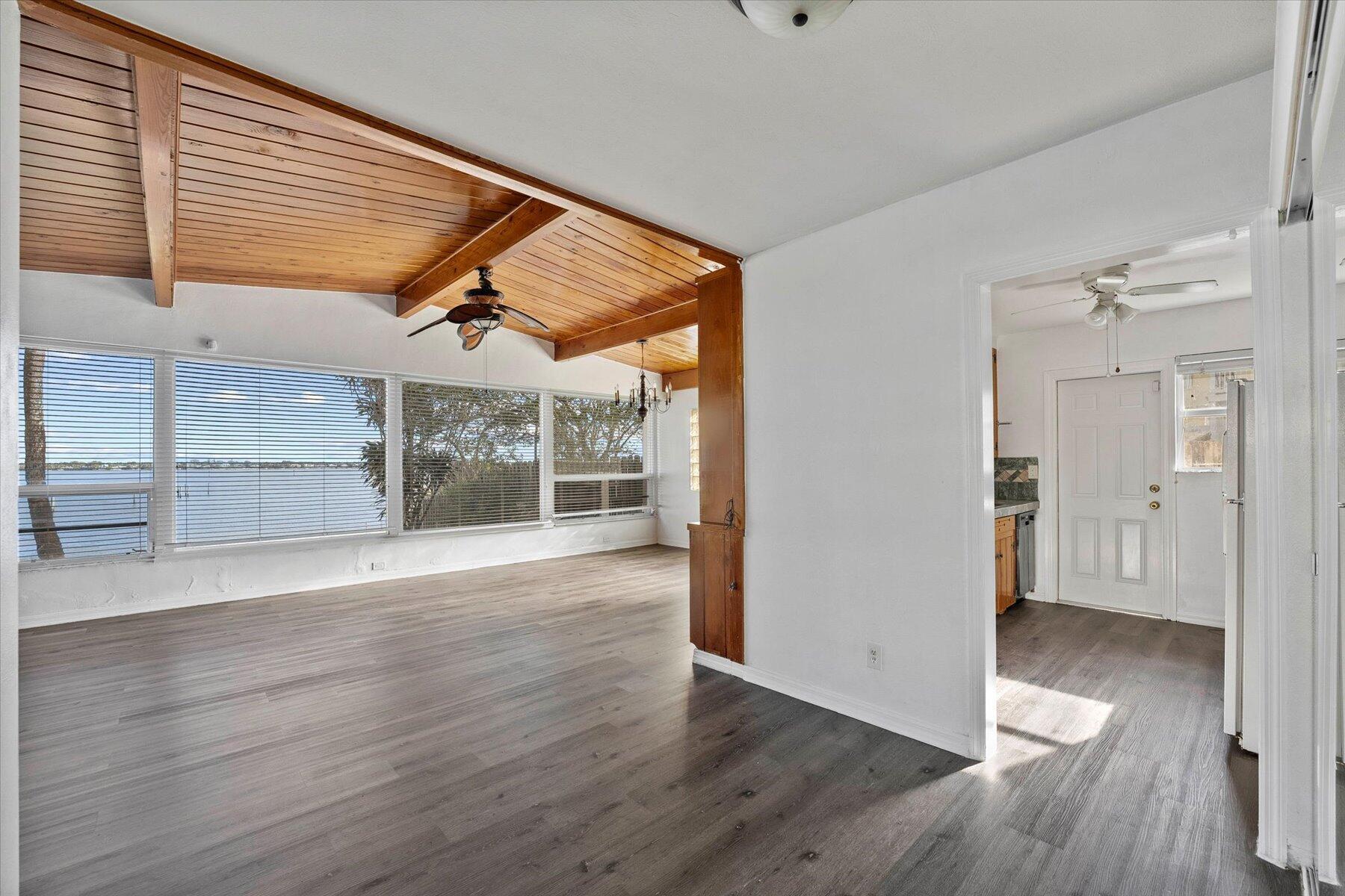101 South Colorado Avenue Stuart, FL 34994 - Photo 7 of 17 an empty room with wooden floor and windows