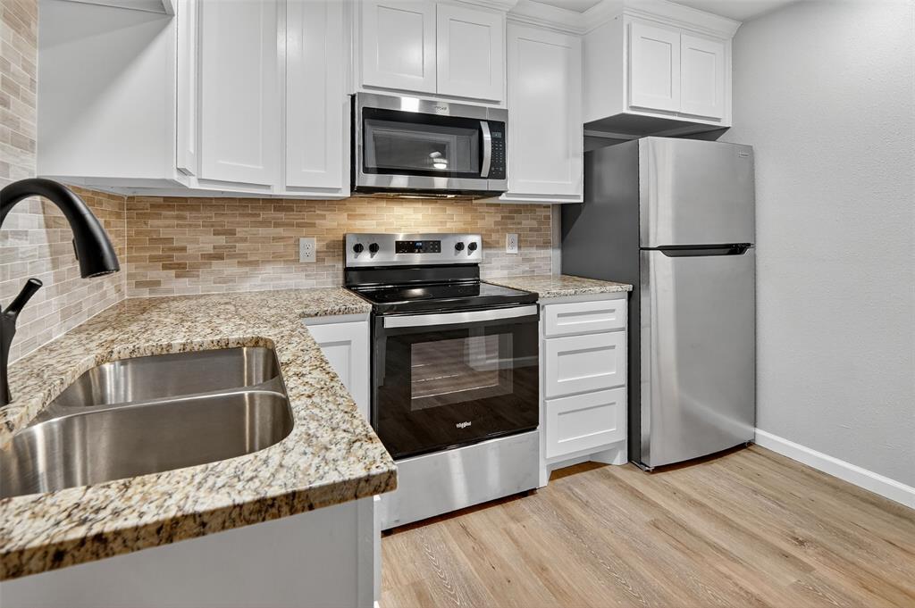 9256 Apt 300 S Fm 51 Boyd, TX 76023 - Photo 8 of 12 a kitchen with granite countertop wooden cabinets stainless steel appliances and a counter space