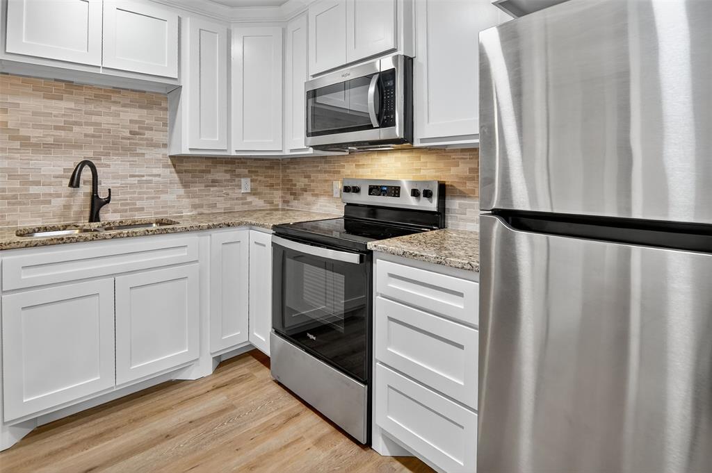9256 Apt 300 S Fm 51 Boyd, TX 76023 - Photo 9 of 12 a kitchen with stainless steel appliances a stove microwave and sink