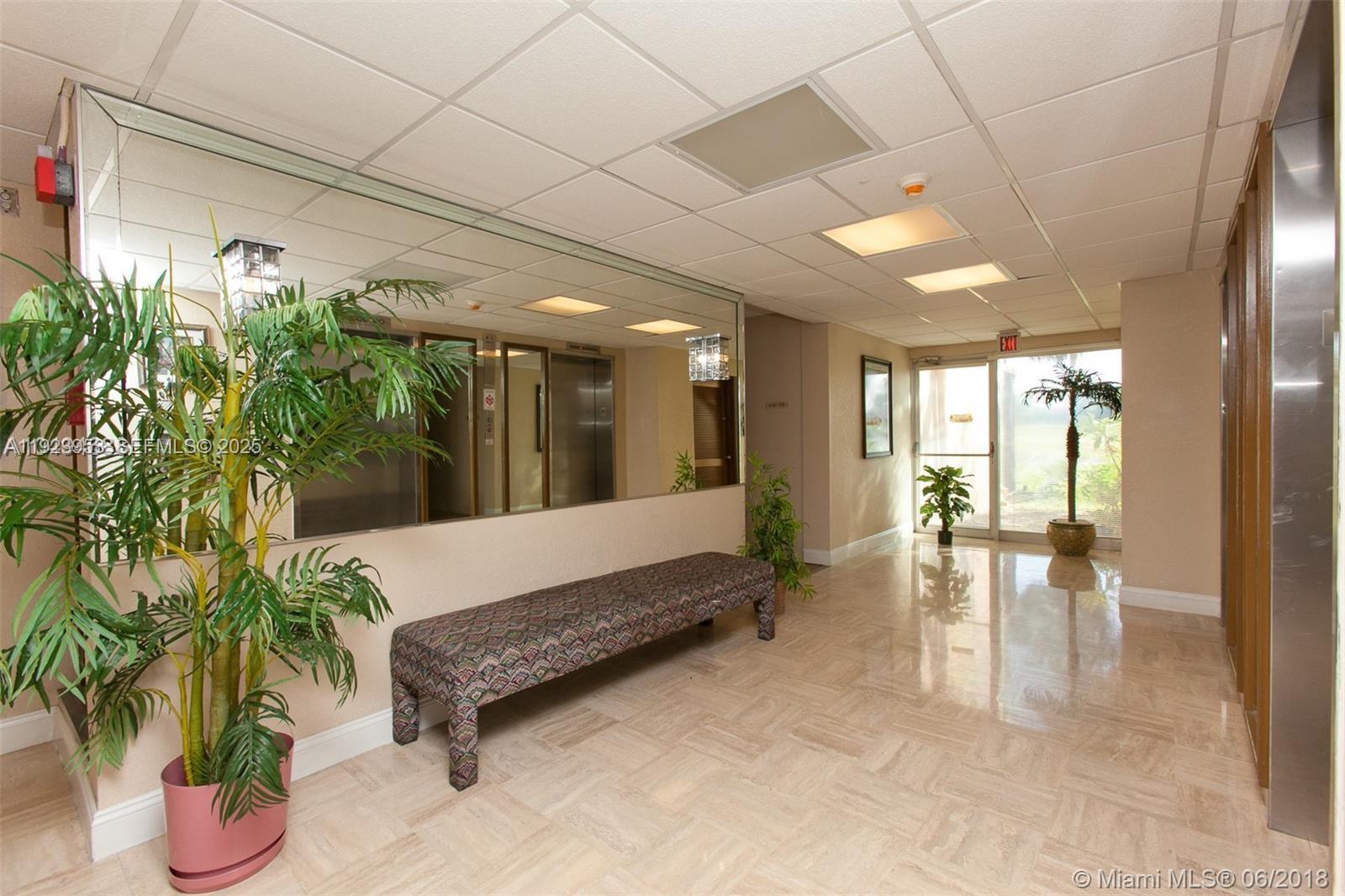 3821 Environ Boulevard, Unit 107 Lauderhill, FL 33319 - Photo 15 of 19 a lobby with furniture and potted plant