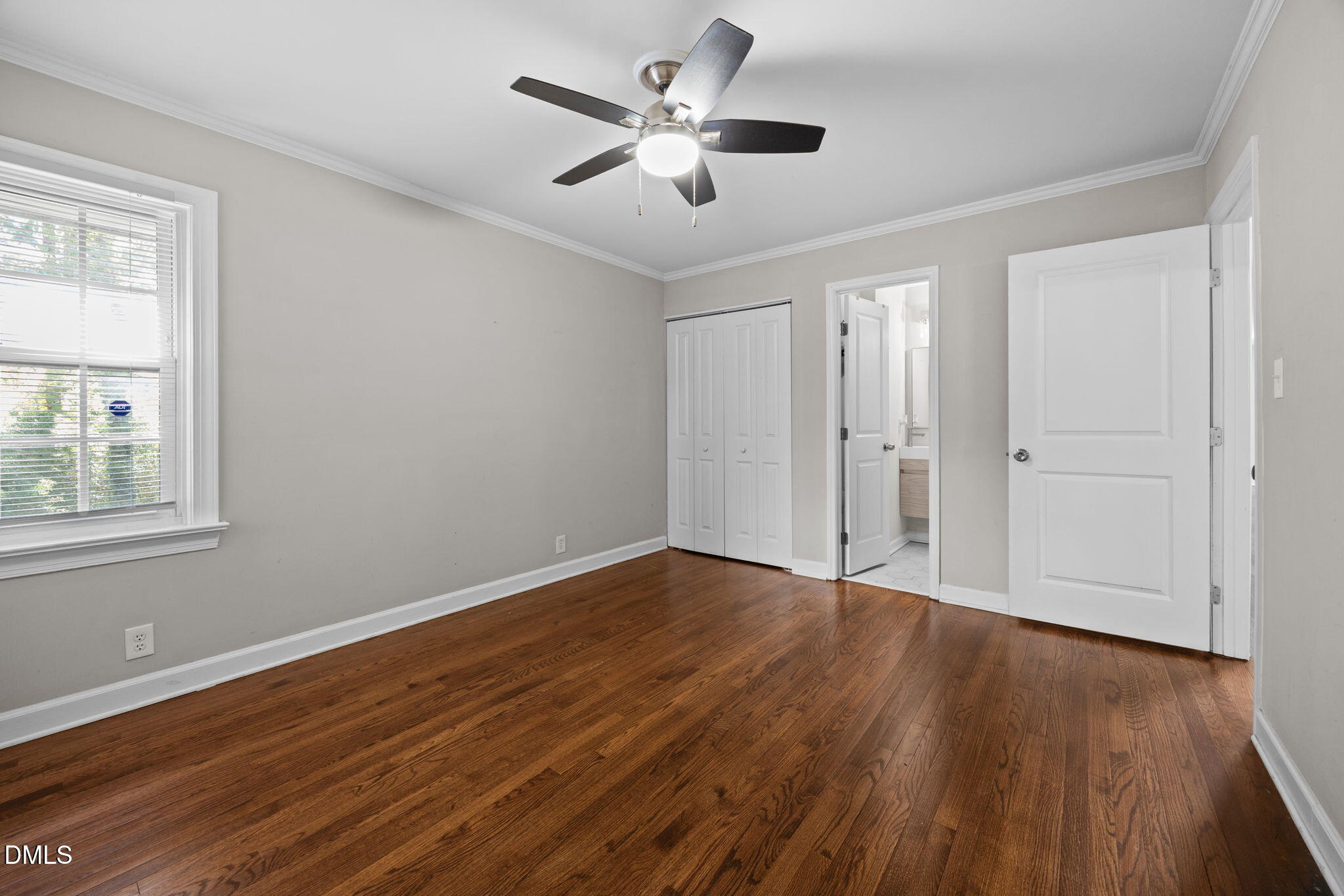 2950 Glenridge Drive Raleigh, NC 27604 - Photo 21 of 53 a view of an empty room with wooden floor and a window