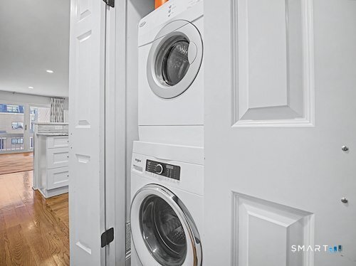 9 River Road, Unit 418 Greenwich, CT 06807 - Photo 16 of 38 a view of a hallway with washer and dryer