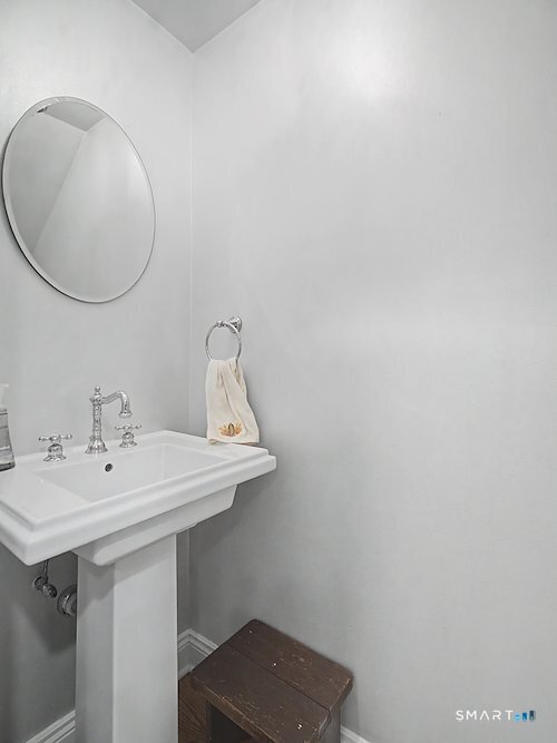 9 River Road, Unit 418 Greenwich, CT 06807 - Photo 18 of 38 a bathroom with a sink and a mirror