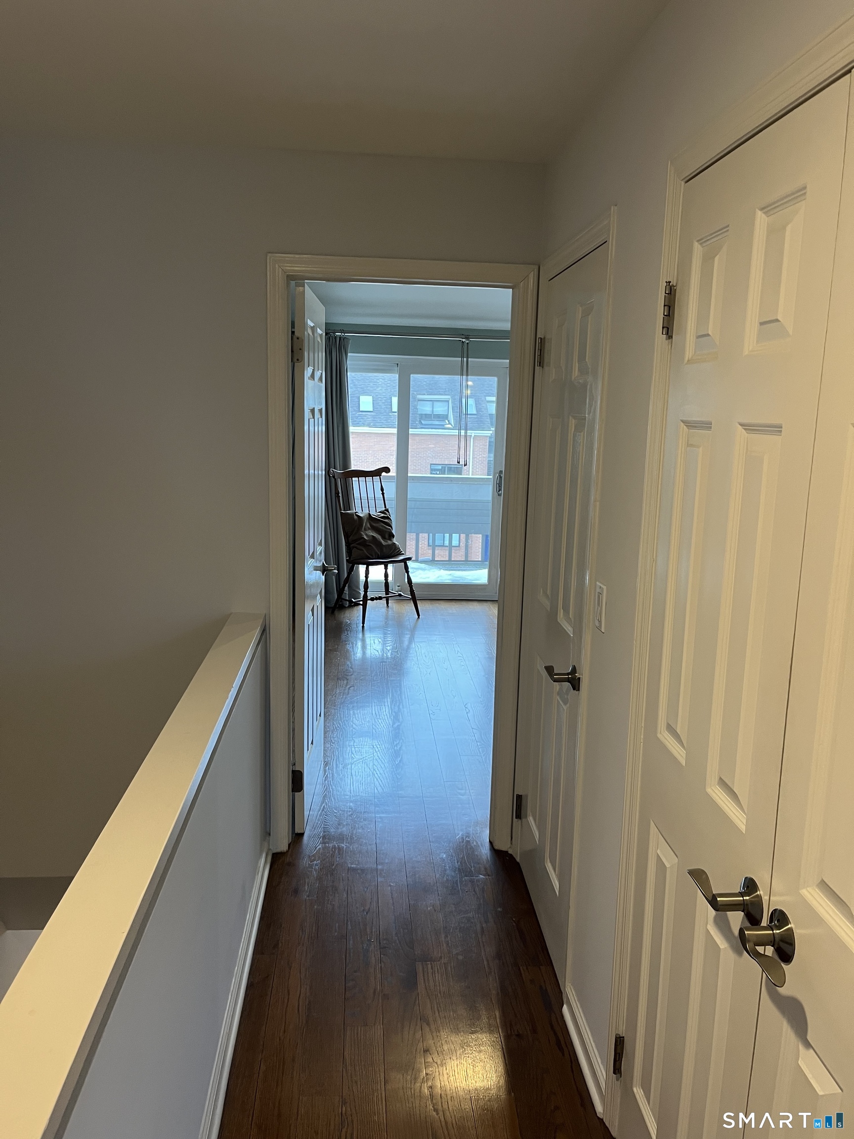 9 River Road, Unit 418 Greenwich, CT 06807 - Photo 19 of 38 a view of a hallway with wooden floor and a bathroom