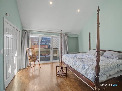 9 River Road, Unit 418 Greenwich, CT 06807 - Photo 22 of 38 a bedroom with a bed and wooden floor