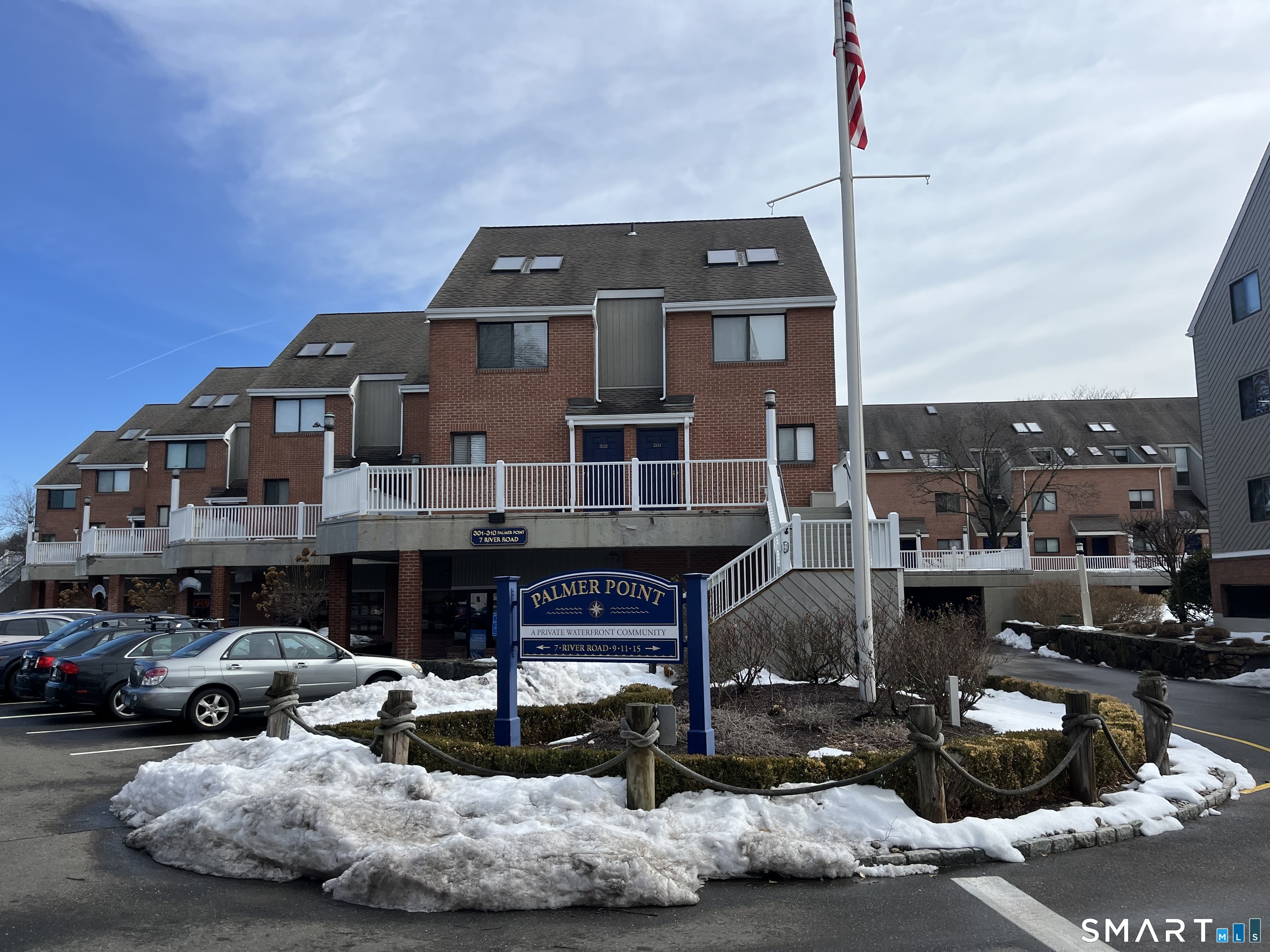 9 River Road, Unit 418 Greenwich, CT 06807 - Photo 29 of 38 a front view of a house with a garden and parking