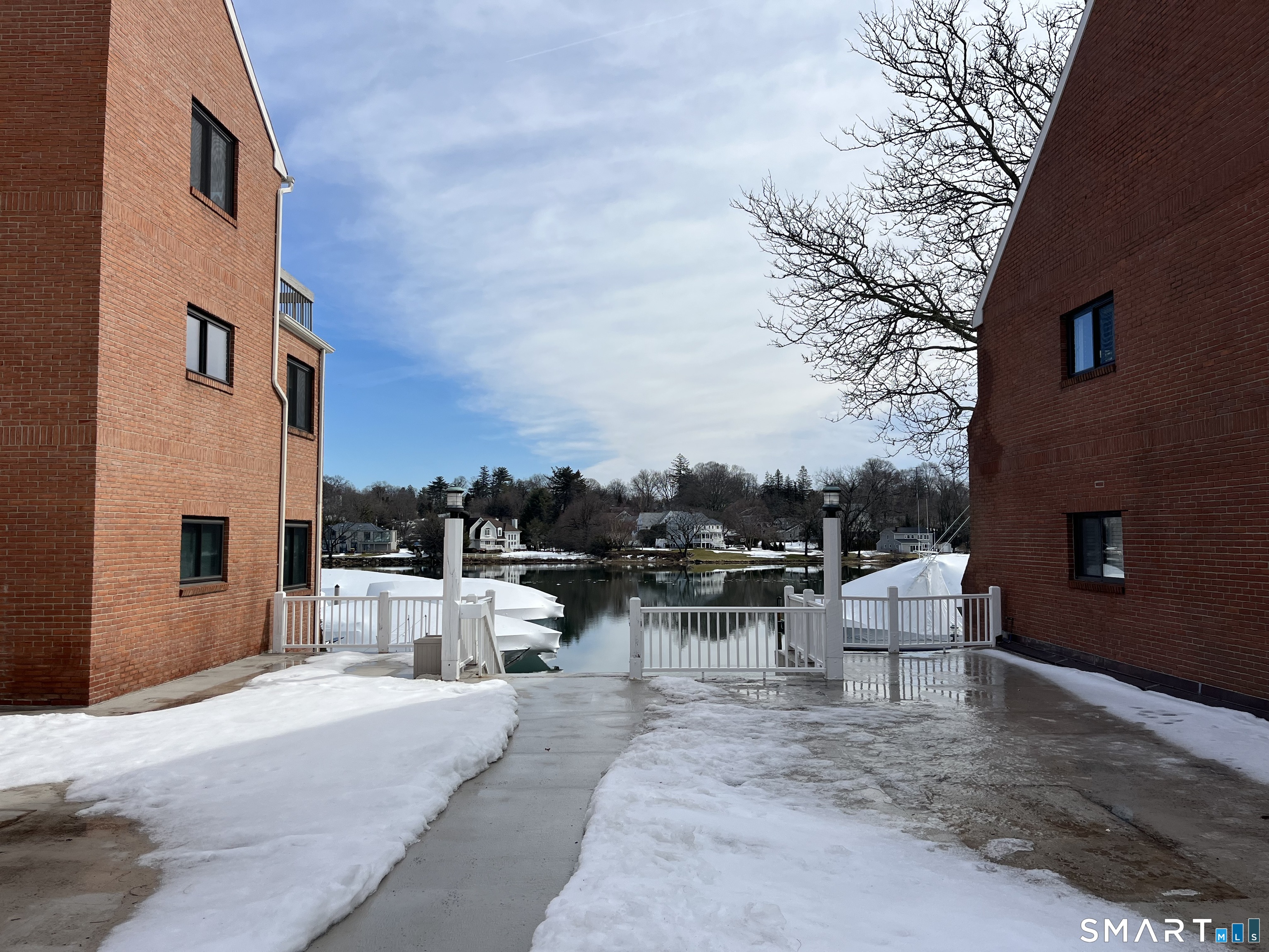 9 River Road, Unit 418 Greenwich, CT 06807 - Photo 31 of 38 a view of a patio with couches and chairs under an umbrella