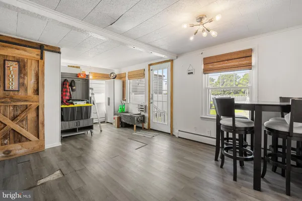 a view of a livingroom with furniture hardwood floor and a window