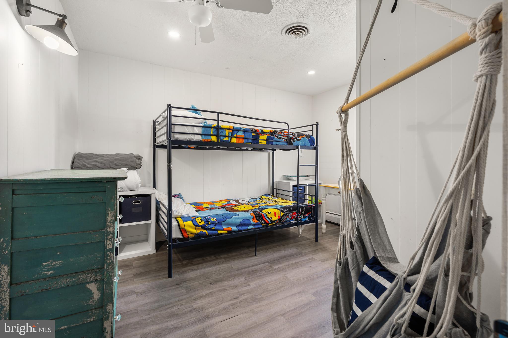 1123 Ball Park Road Fishing Creek, MD 21634 - Photo 25 of 39 a bedroom with furniture and a wooden floor