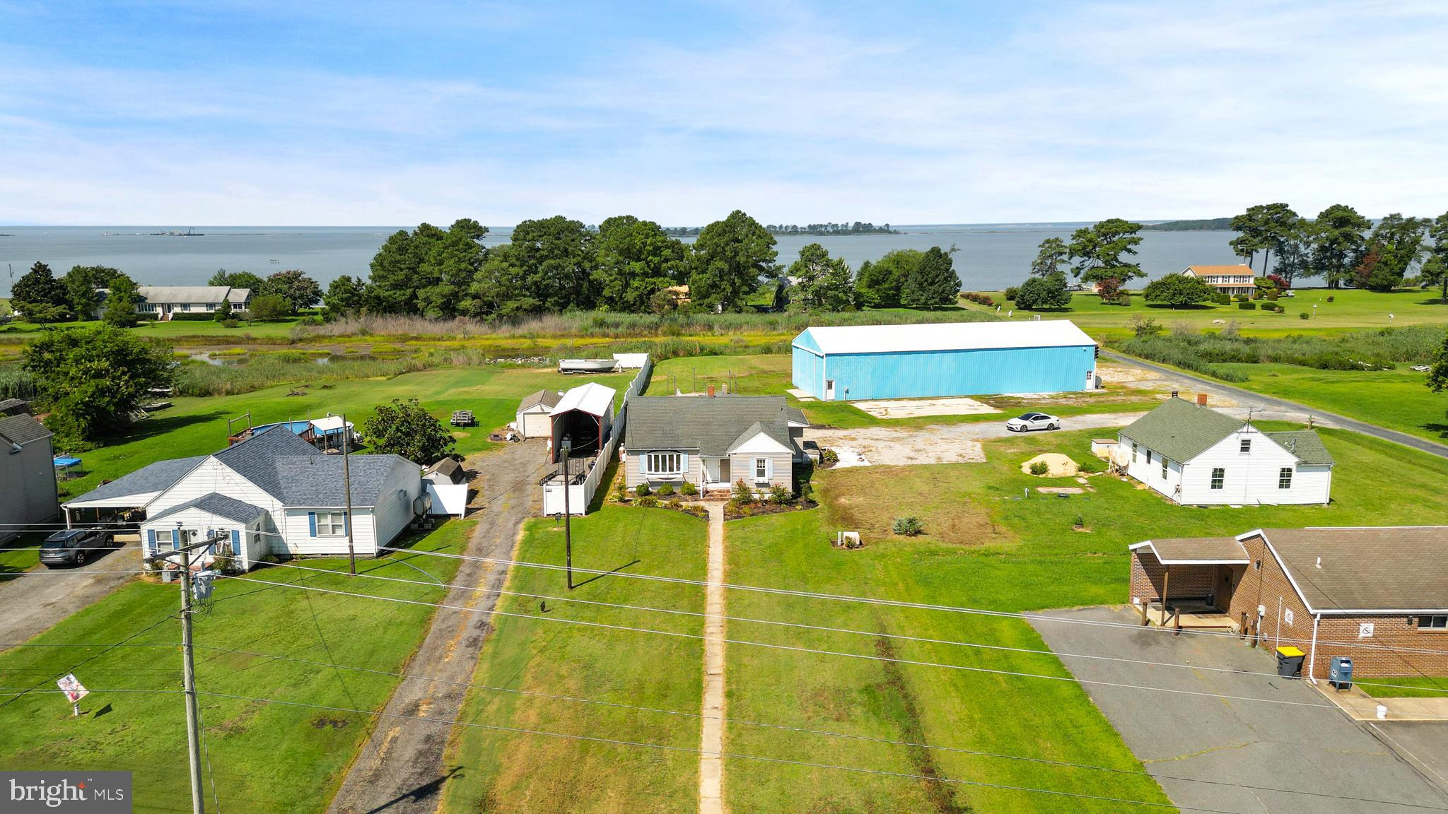 1123 Ball Park Road Fishing Creek, MD 21634 - Photo 7 of 39 a view of a lake with lawn chairs