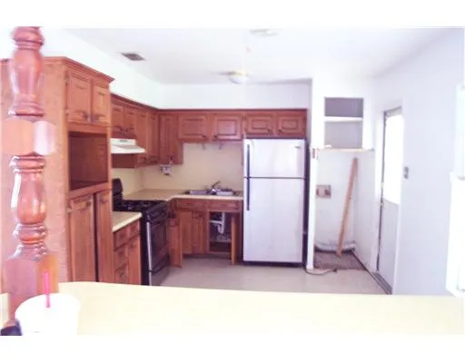 a kitchen with refrigerator and cabinets