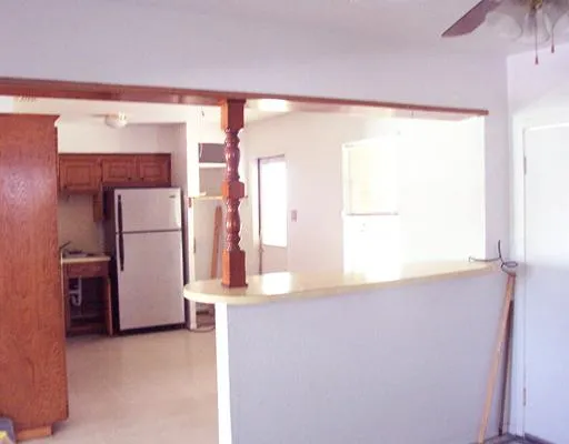 a view of a kitchen with a refrigerator and a window