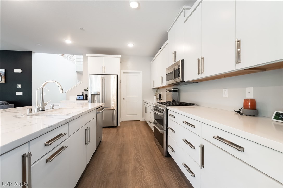 2166 Trivero Street Henderson, NV 89044 - Photo 14 of 61 Culinary delights await in this bright kitchen with premium appliances and generous counter space.