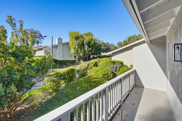 a view of a balcony with flower plants