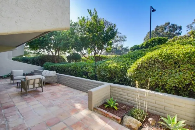 a view of an outdoor sitting area with wooden fence