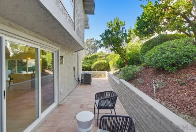 a view of a porch with furniture and a yard