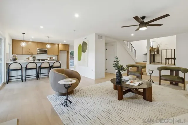 a living room with furniture and a chandelier