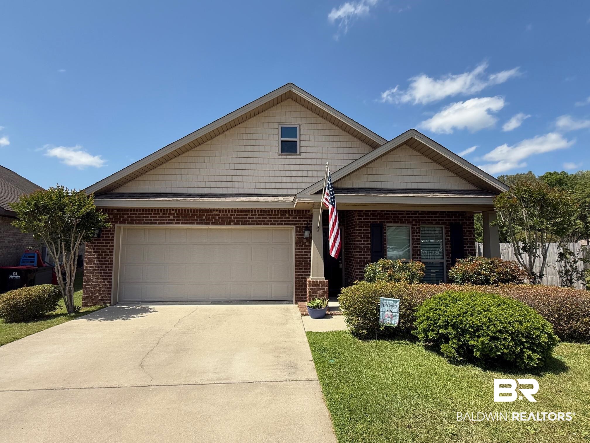 2996 Notsram Court Mobile, AL 36695 - Photo 1 of 16 View of front of home featuring brick siding, a front yard, concrete driveway, and an attached garage