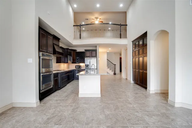 a kitchen with stainless steel appliances granite countertop a sink and a stove