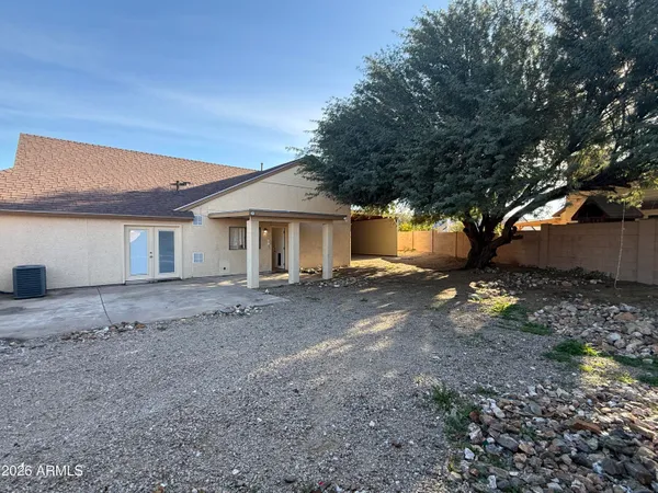 a view of a house with a yard and a tree
