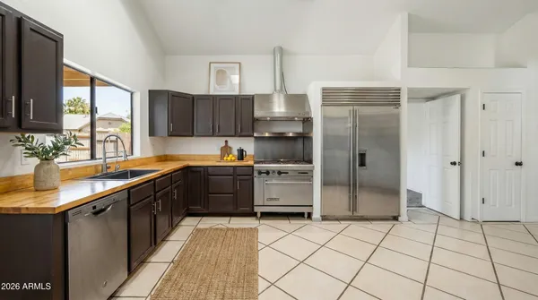 a kitchen with stainless steel appliances a refrigerator sink and cabinets
