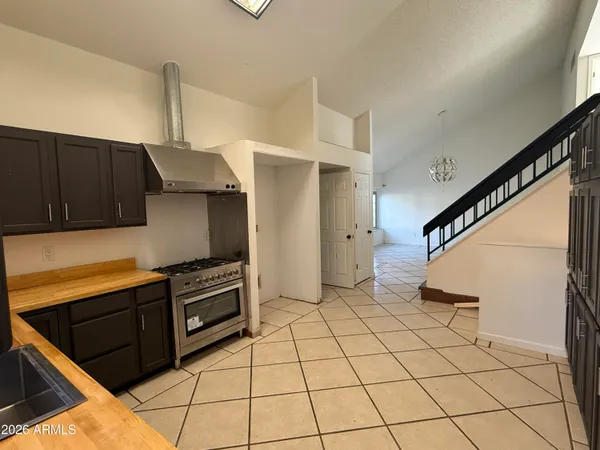 a kitchen with a stove a refrigerator and cabinets