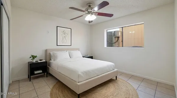 a bedroom with a bed and window
