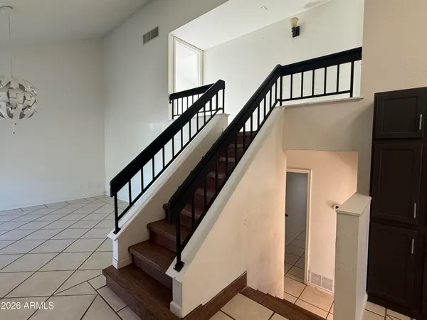 a view of entryway with wooden floor and stairs