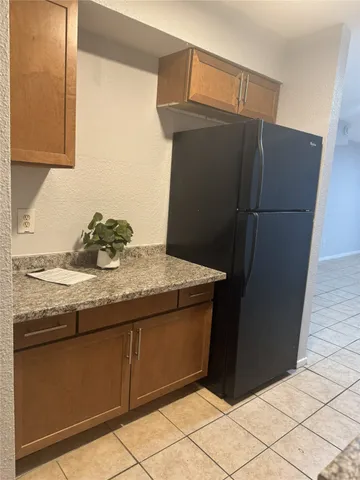 a kitchen with a sink and a refrigerator