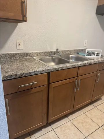 a view of a kitchen with granite countertop cabinets and utility