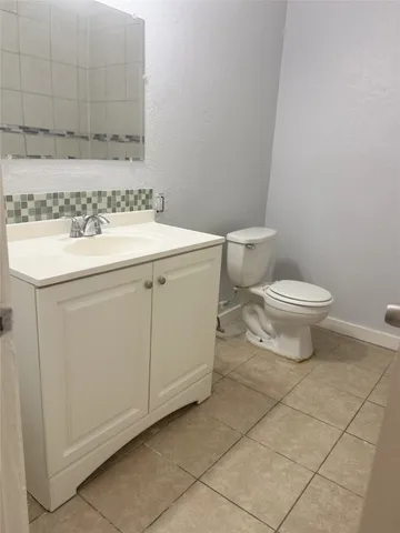 a bathroom with a sink toilet and vanity