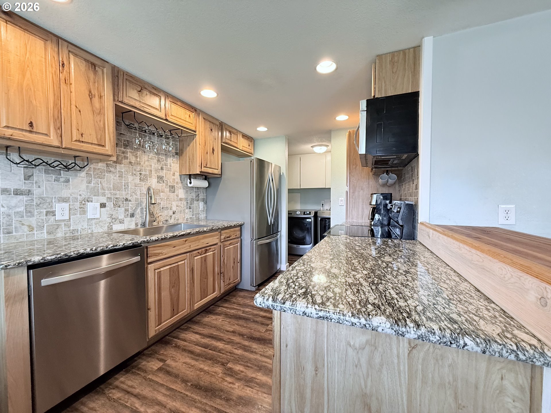 370 North Wall Street Coos Bay, OR 97420 - Photo 12 of 36 a kitchen with stainless steel appliances granite countertop a sink and a stove